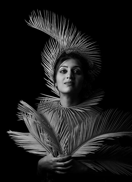 Woman crowned in radiating palm fronds