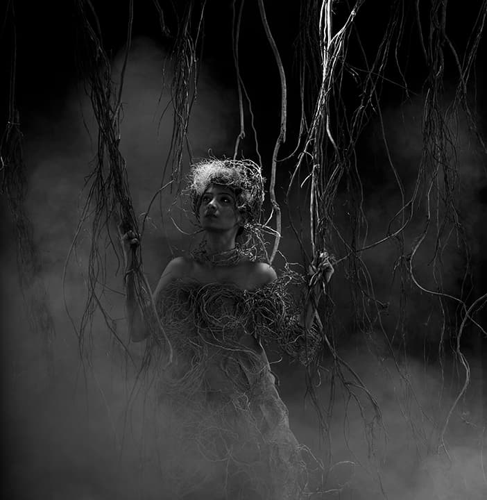 Figure dressed in tangled roots