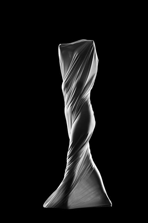 Figure twisted in white fabric