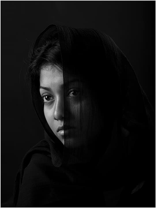 Translucent veil bisecting a chiaroscuro face