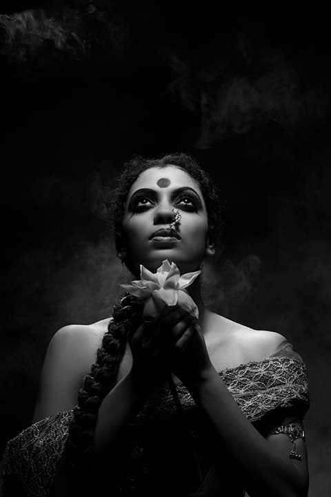 Woman with lotus in prayer