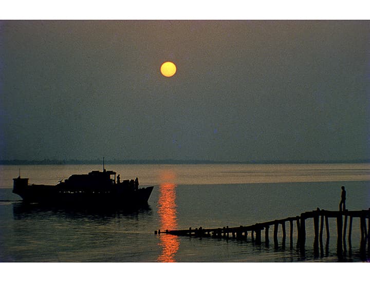 Dusk river with a single boat